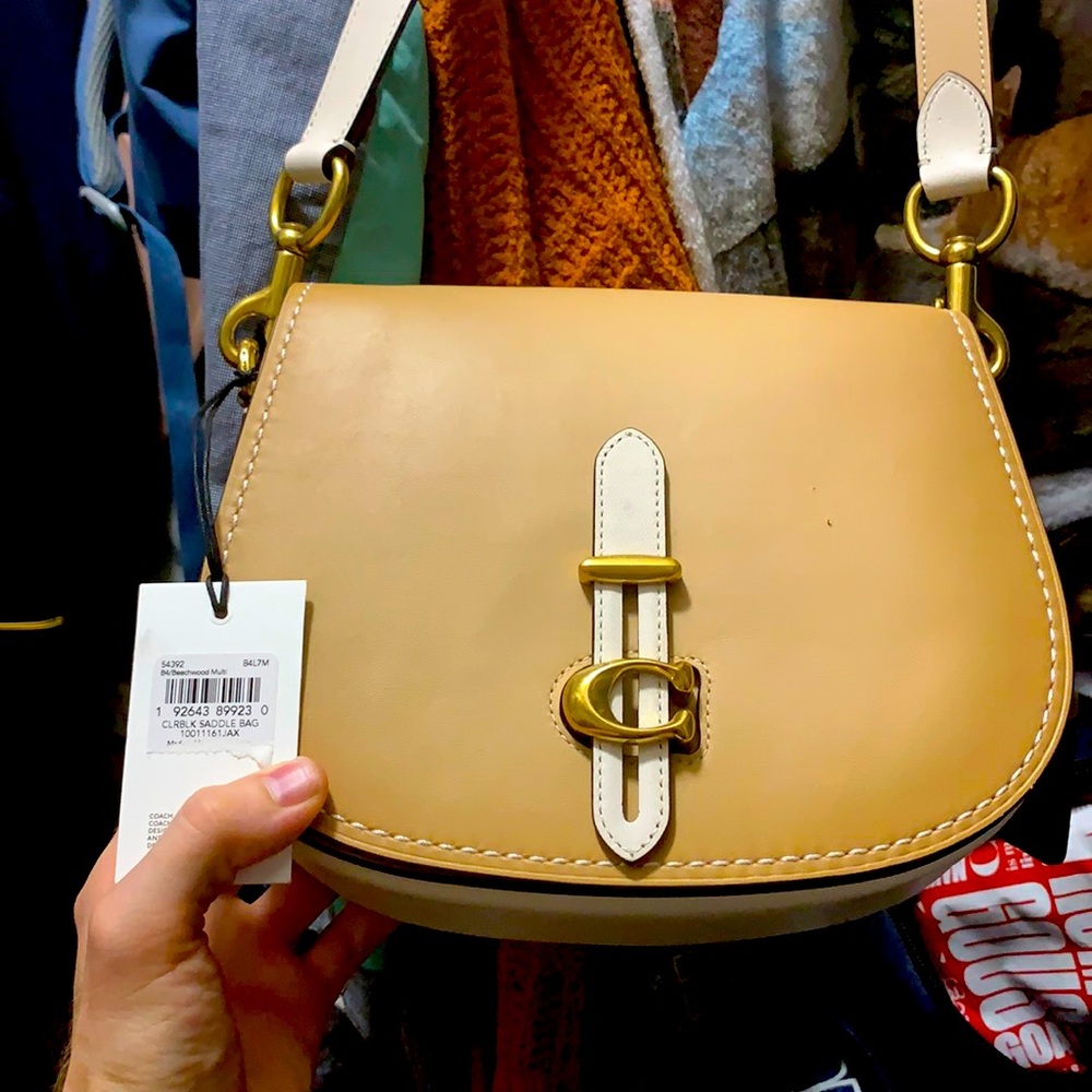 Cream colored coach saddle bag